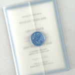 Transparent vellum wedding invite in dusty blue wax seal