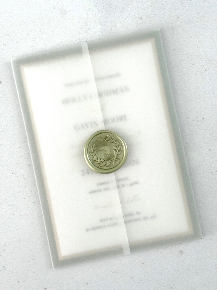 Handmade wedding invite with transparent vellum wrap and wax seal closure