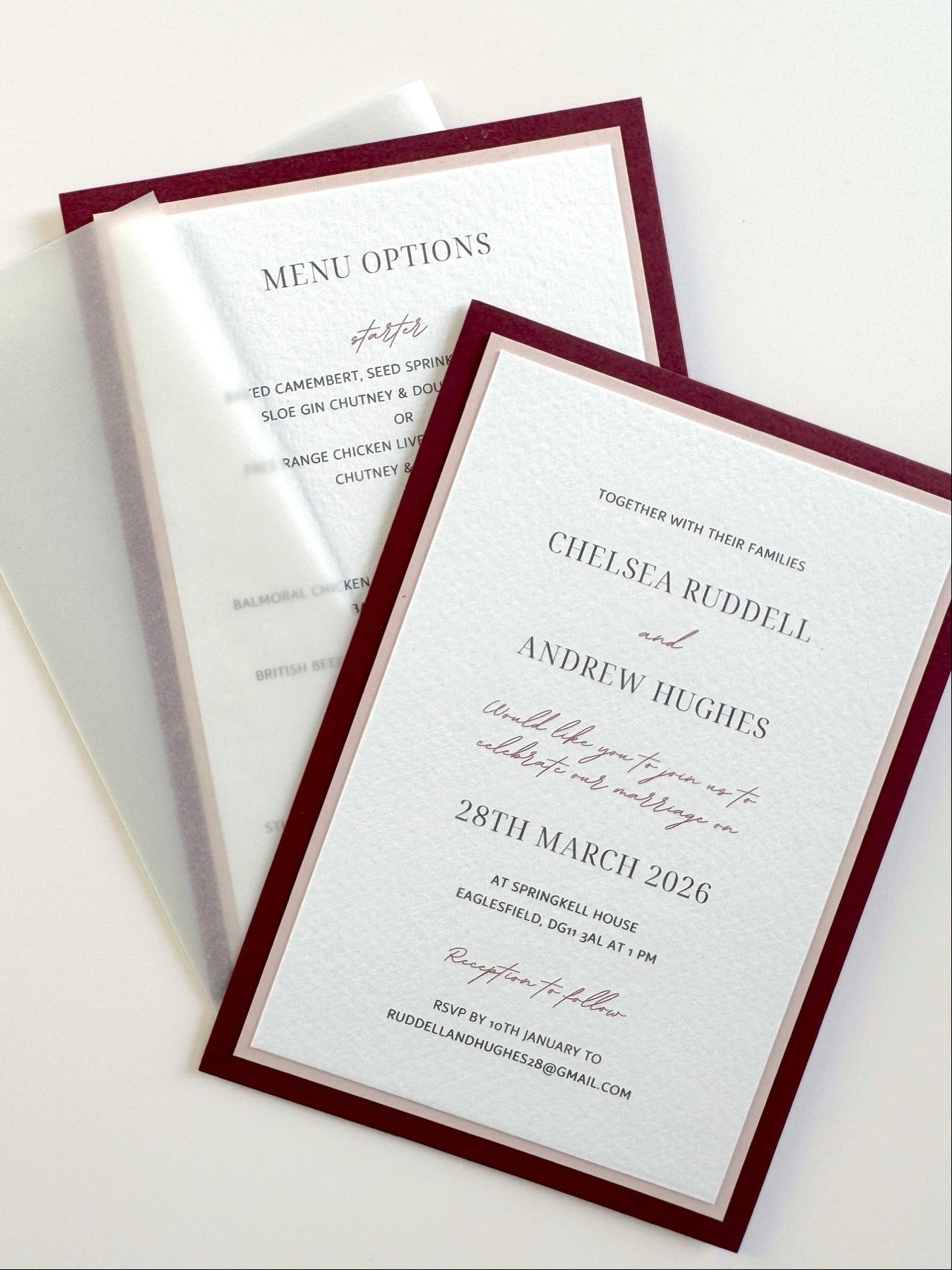 Burgundy wedding invite with transparent vellum paper wrap and wax seal
