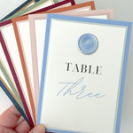 dusty blue wax seal table name on the day wedding stationery