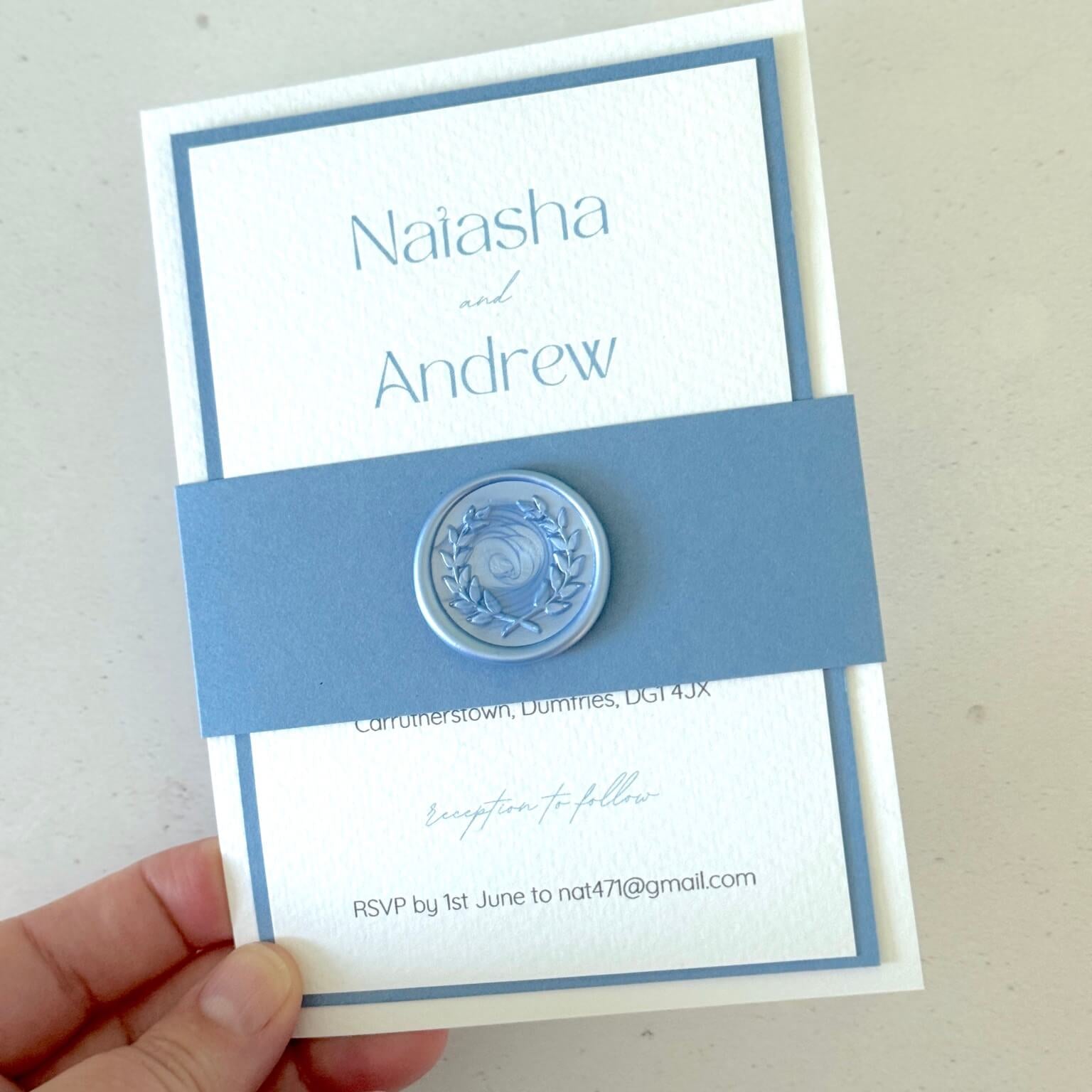 Lyn wedding invite with dusky blue belly band and wax seal