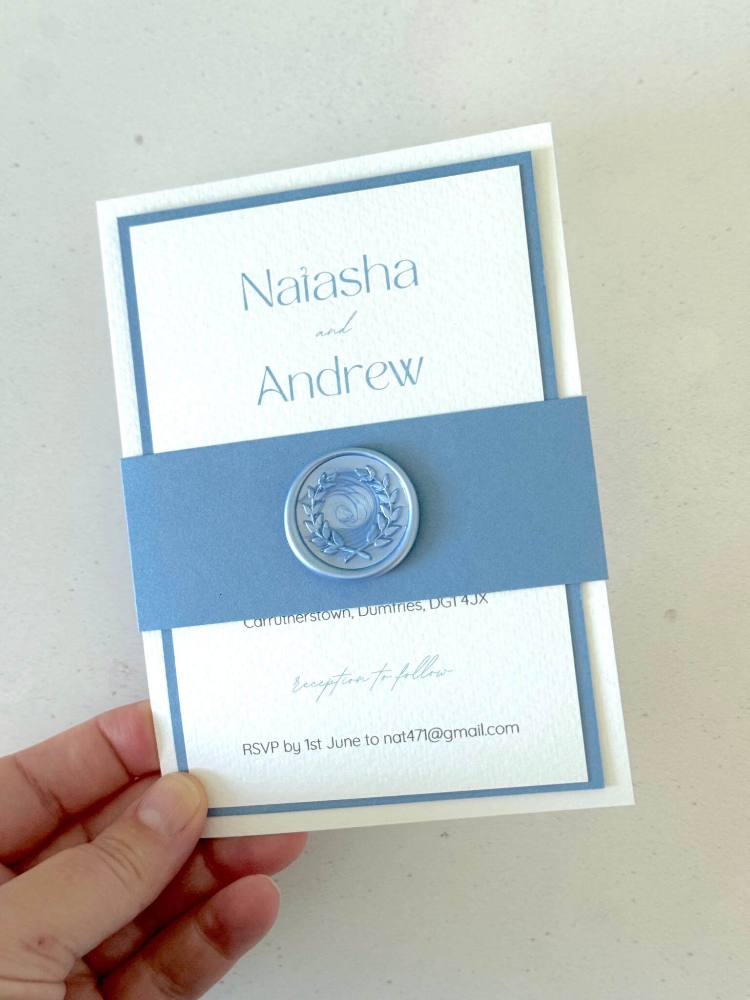Lyn wedding invite with dusky blue belly band and wax seal