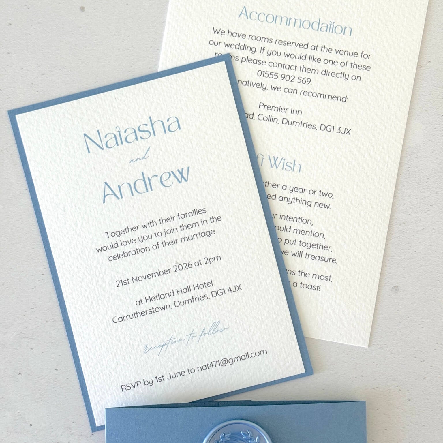 dusty cornflower blue postcard wedding invite and details card with belly band and wreath wax seal