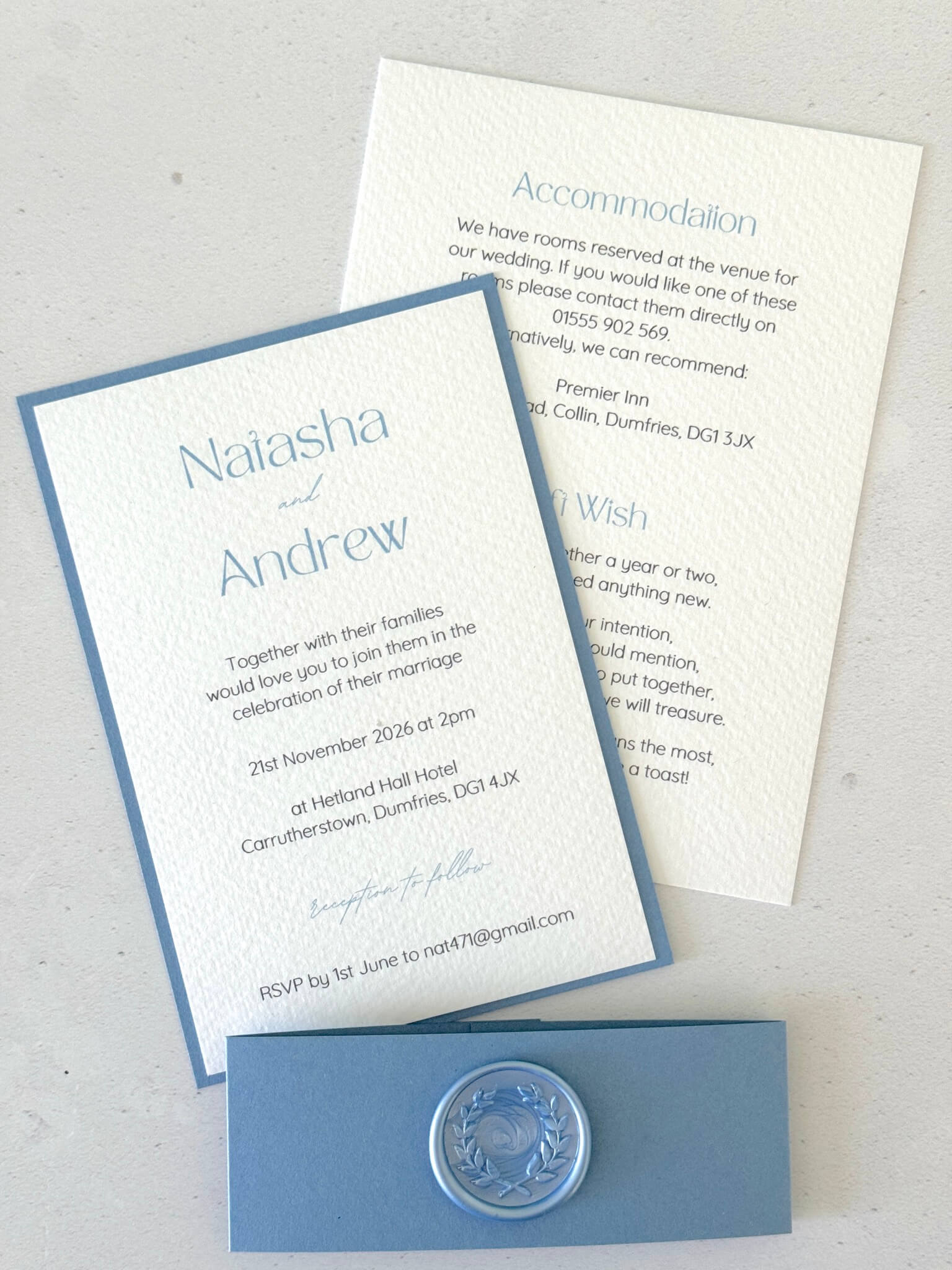 dusty cornflower blue postcard wedding invite and details card with belly band and wreath wax seal