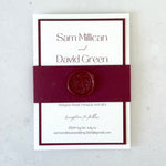 Burgundy and white layered wedding invitation with belly band and wax seal