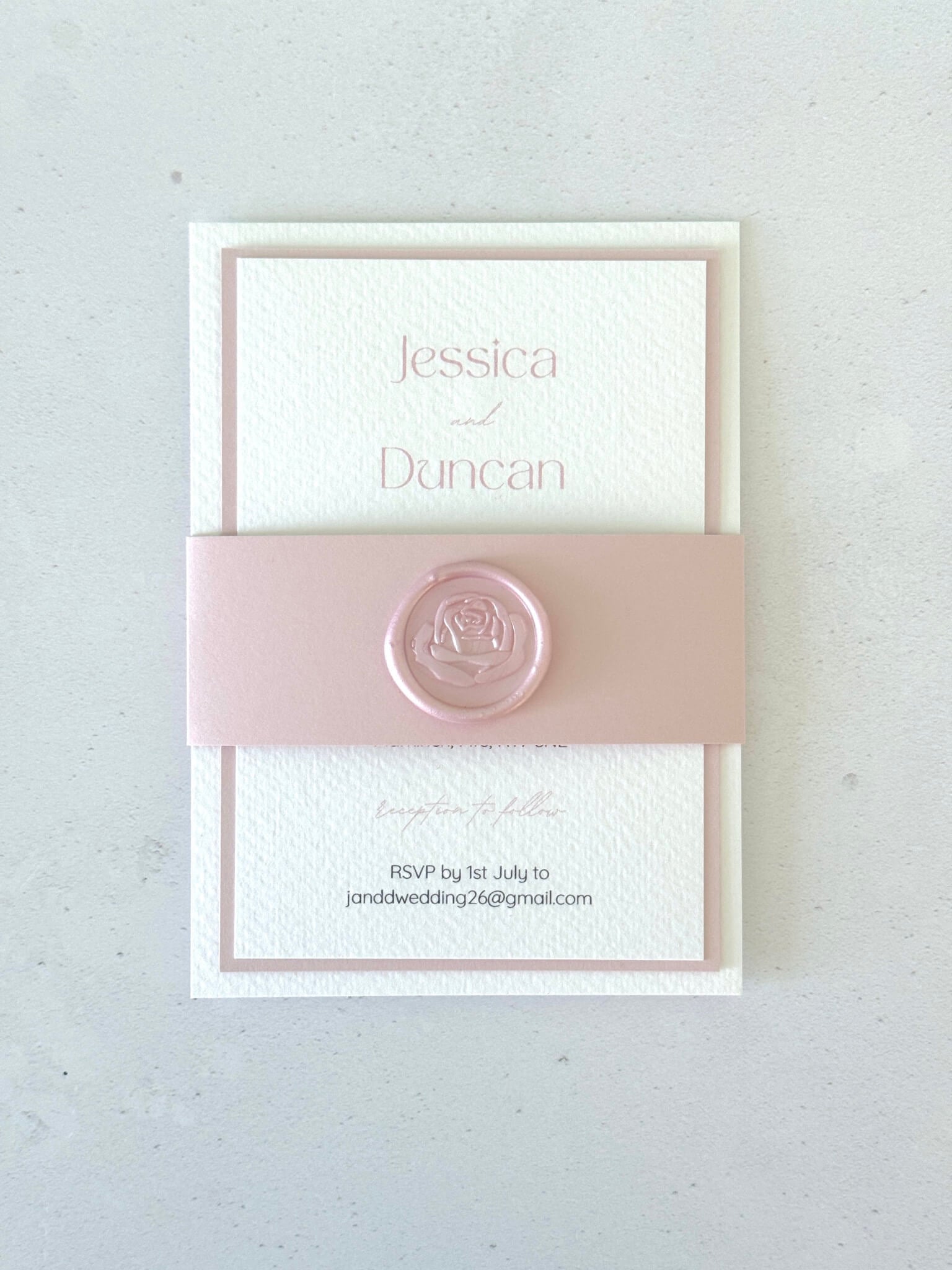 Pink handmade wedding invitation with belly band with wax seal