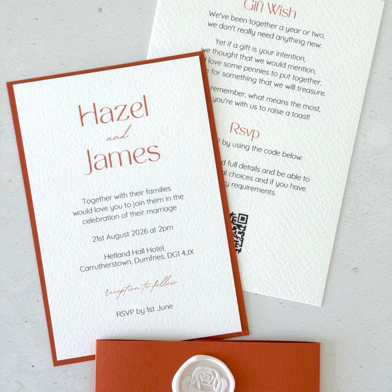 Lyn postcard wedding invite with rust orange belly band and white rose wax seal