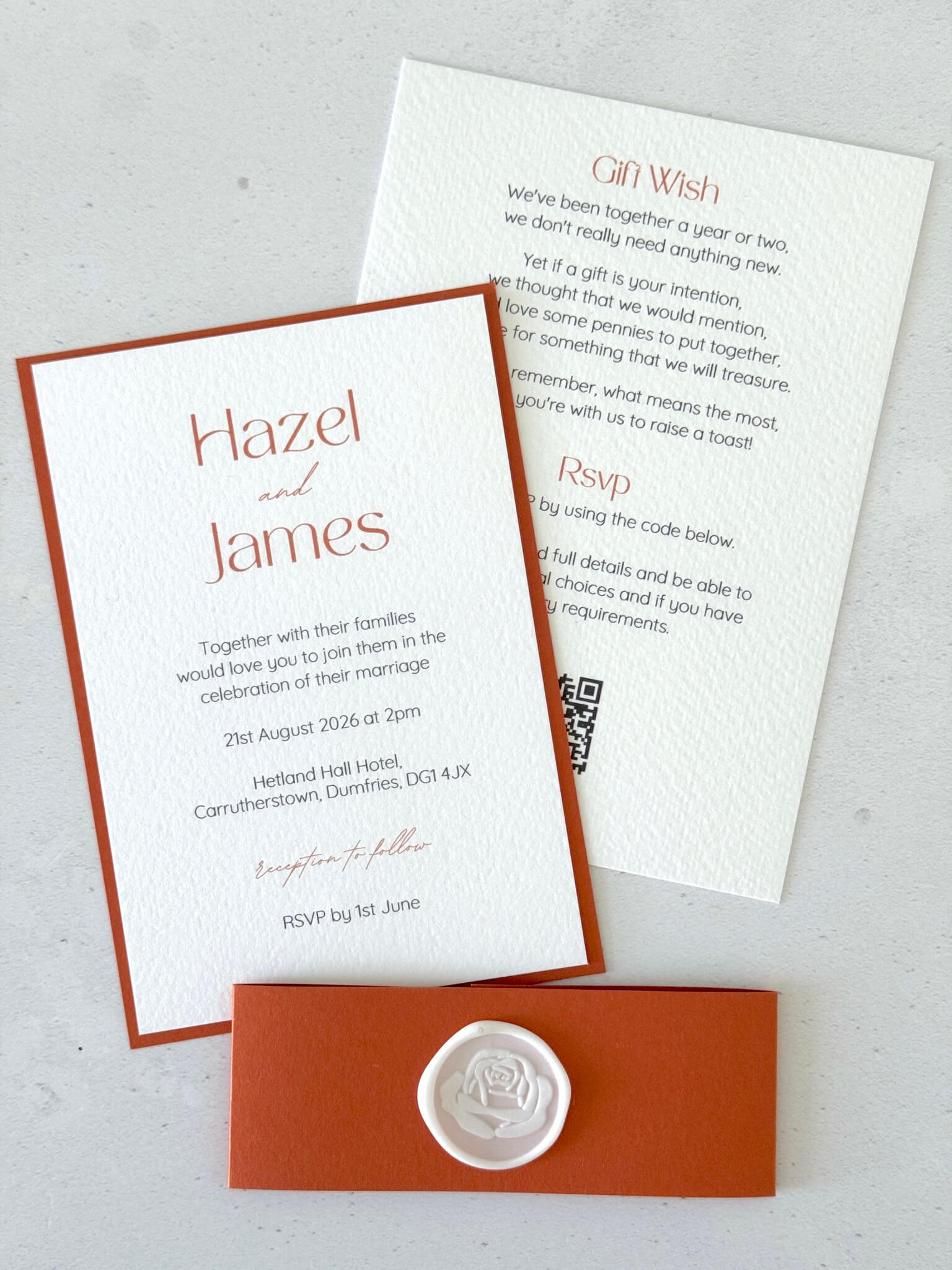 Lyn postcard wedding invite with rust orange belly band and white rose wax seal