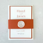 Lyn wedding invite with terracotta orange belly band and white wax seal