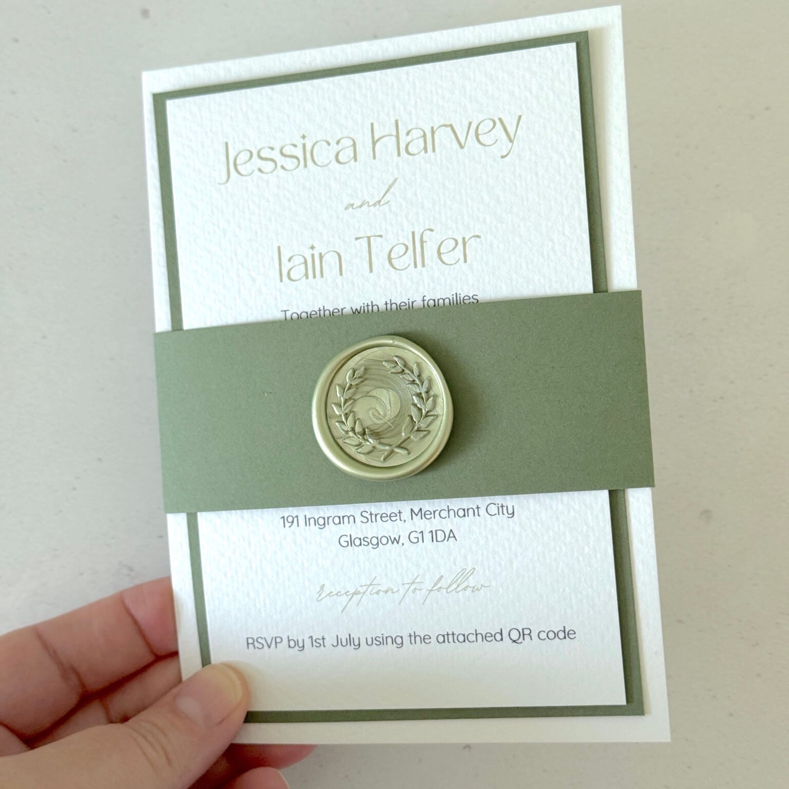 Lyn wedding invite with sage green wax seal and belly band