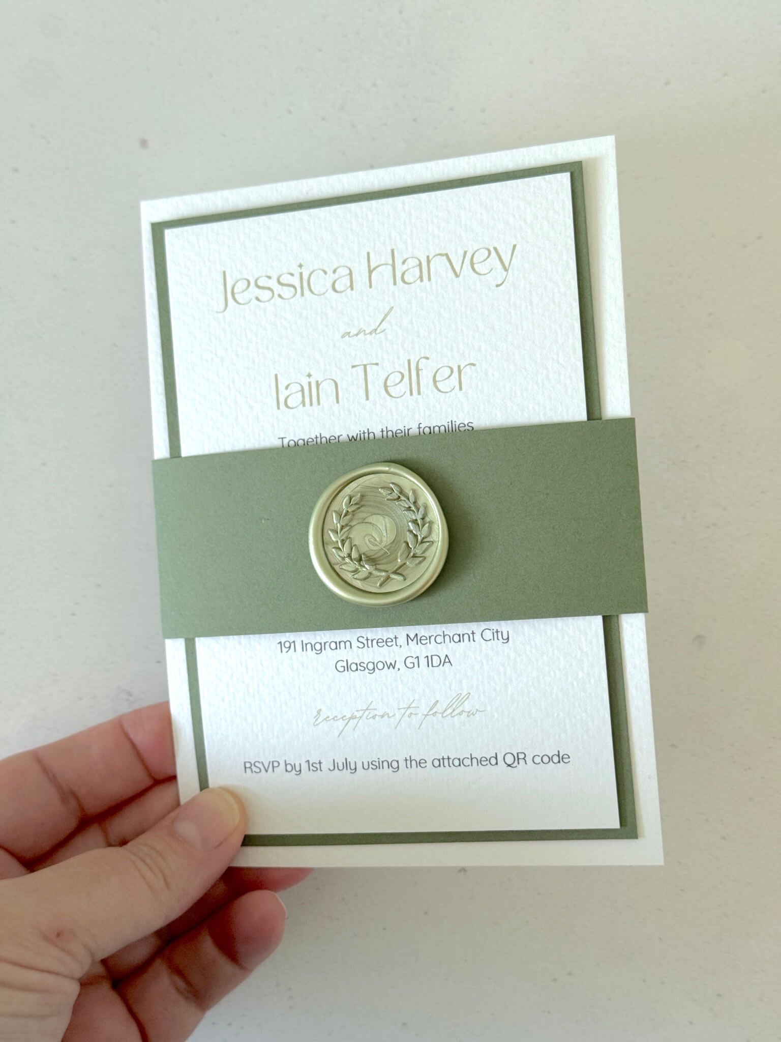 Lyn wedding invite with sage green wax seal and belly band