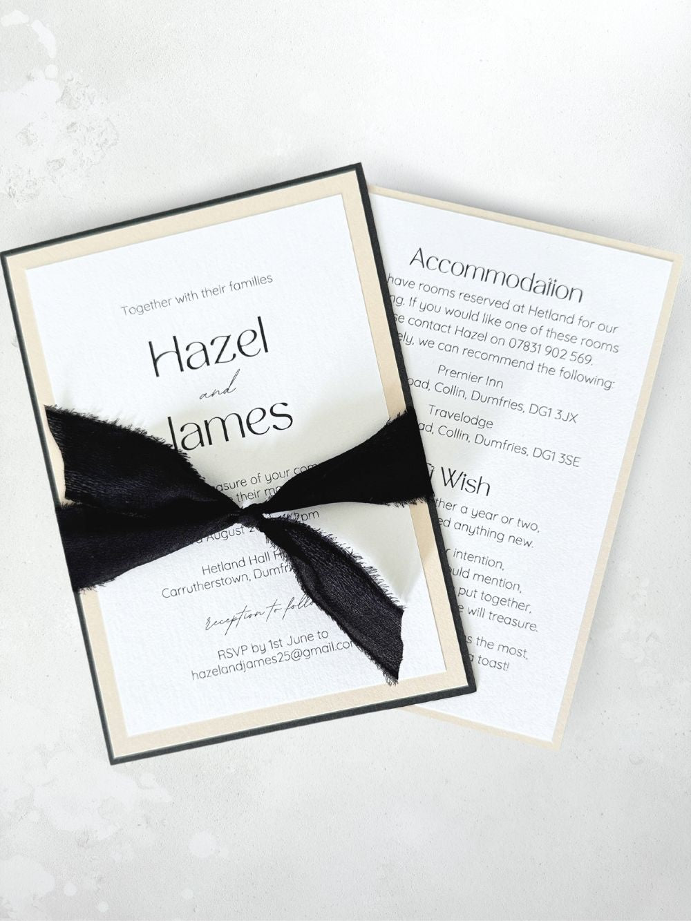 minimalist black white and natural layered wedding invite with tied black silk ribbon