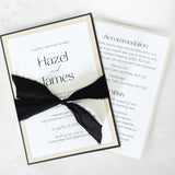 minimalist black white and natural layered wedding invite with tied black silk ribbon