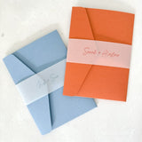 Pocketfold wedding invites with personalised vellum belly bands