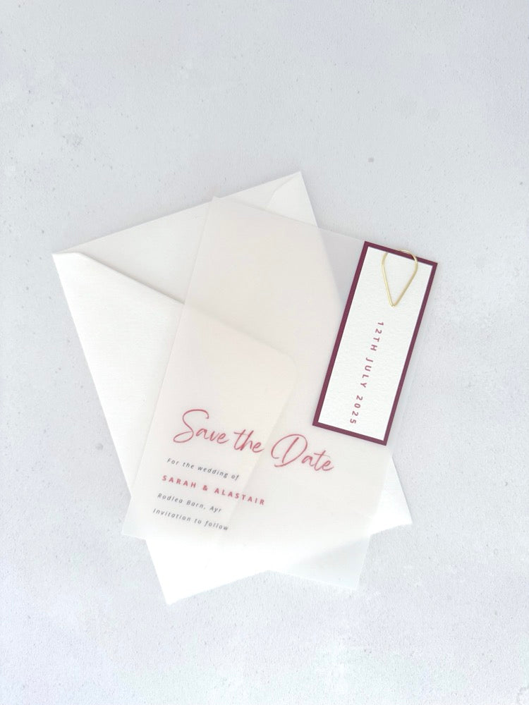 See through vellum save the date card with burgundy date tag and teardrop paperclip