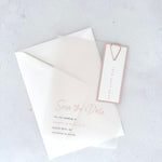 transparent vellum save the date card with blush pink date tag and teardrop paperclip