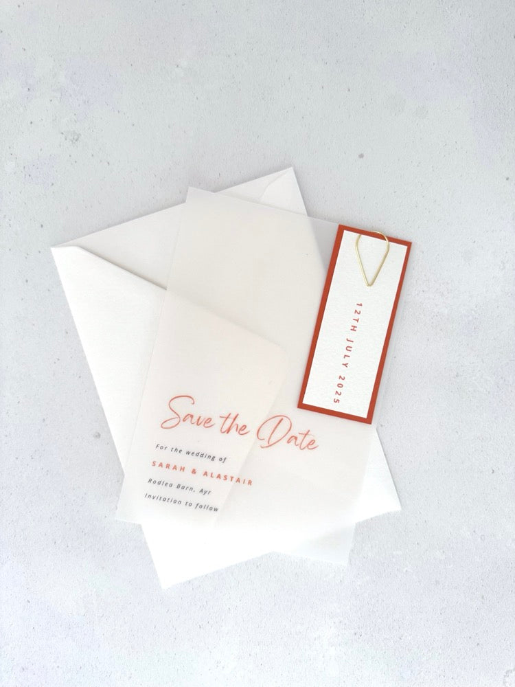 transparent vellum save the date card with rust orange date tag and teardrop paperclip from handmade by zara