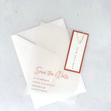 transparent vellum save the date card with rust orange date tag and teardrop paperclip from handmade by zara