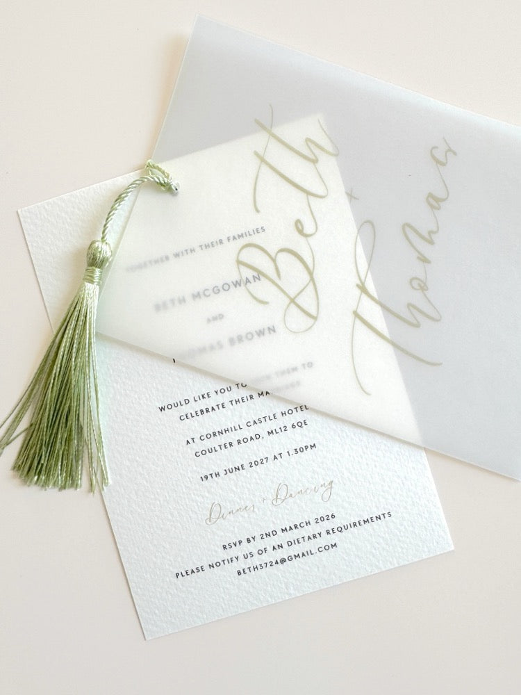 Wedding invitation with sage green tassel and calligraphy font on vellum