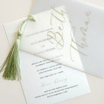 Wedding invitation with sage green tassel and calligraphy font on vellum
