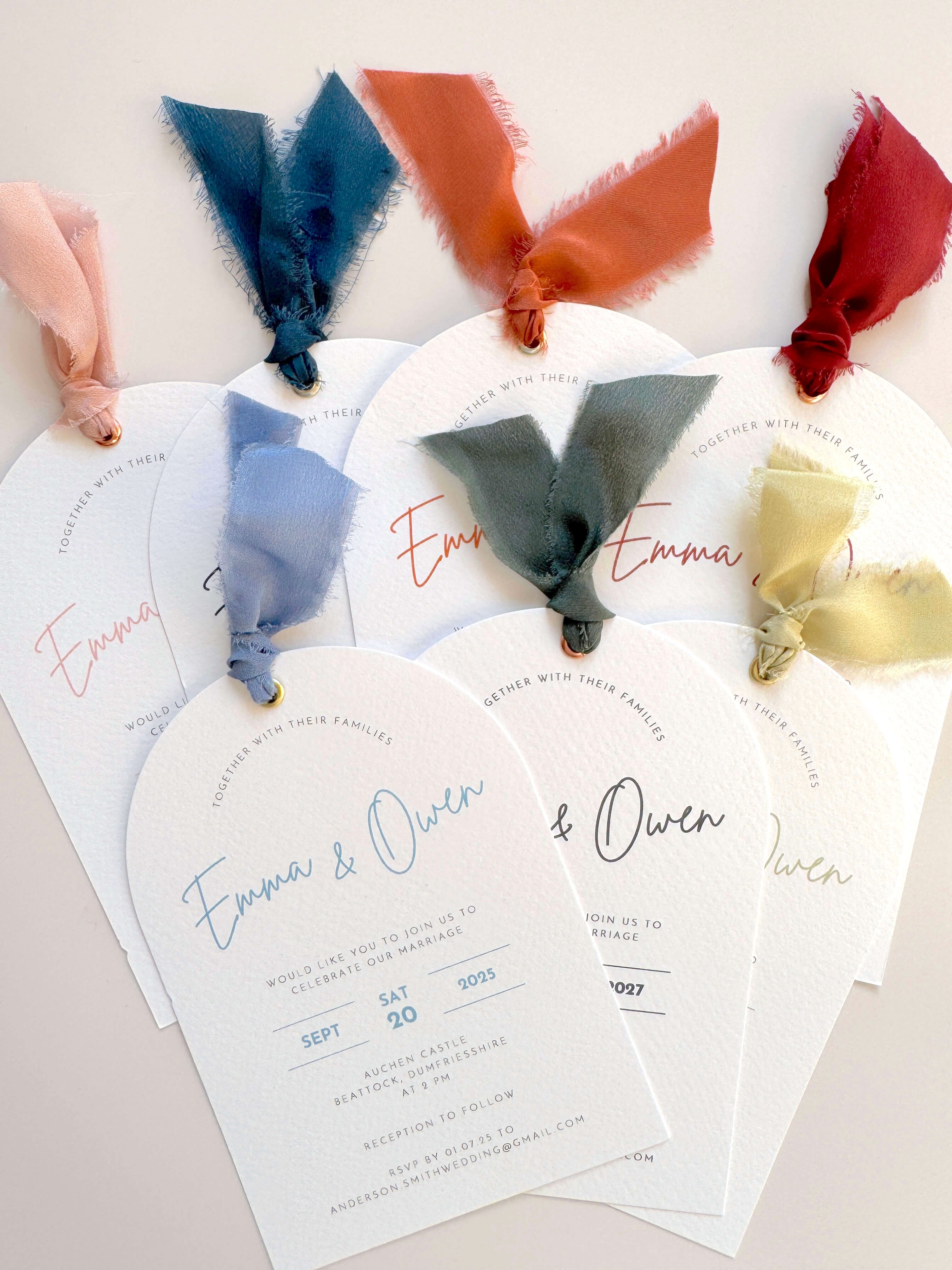 Handmade Emma arch wedding invite with silk ribbon and metal eyelet, in rust, navy, burgundy, sage green, dusky blue, pink, and dark green