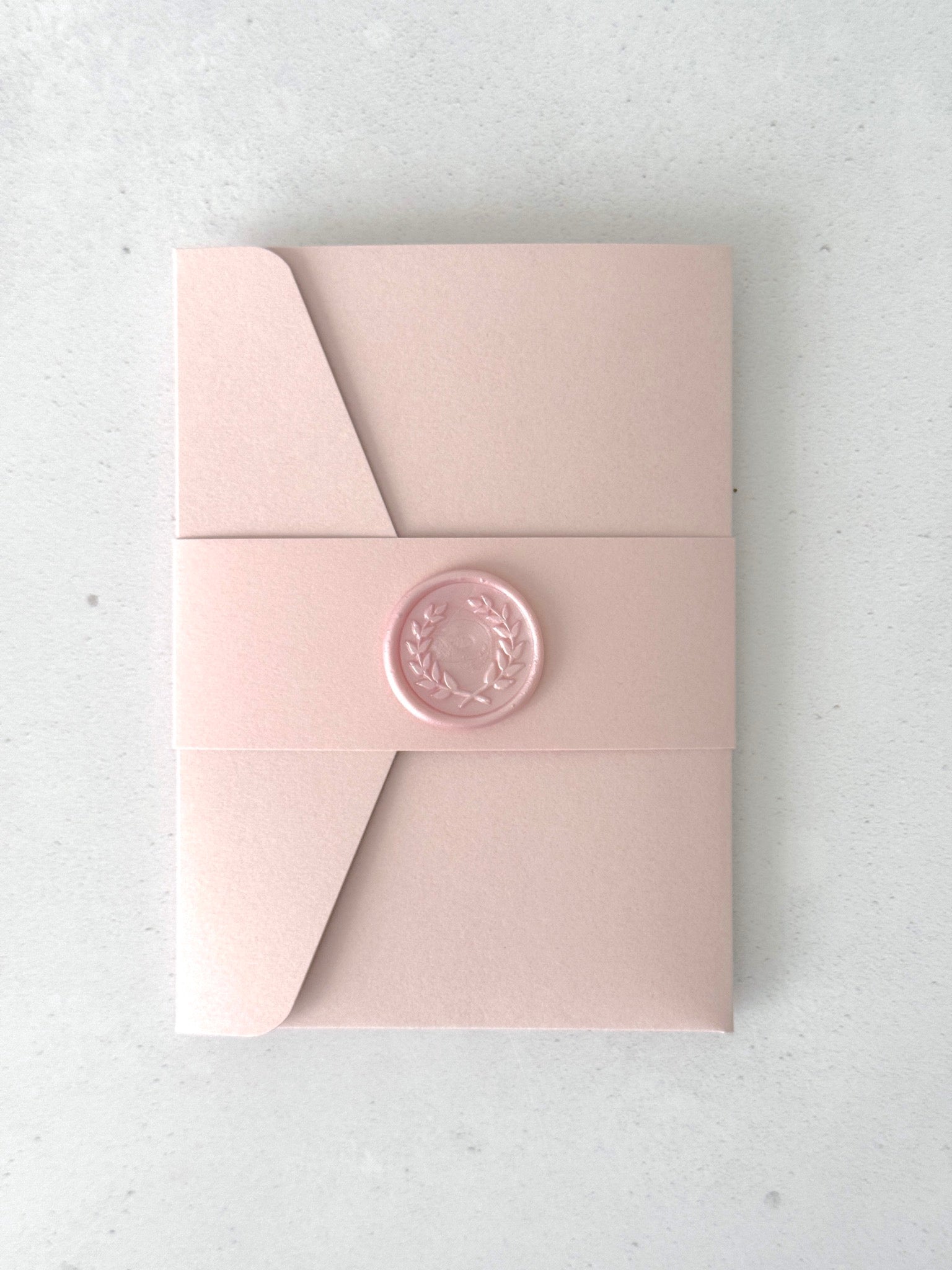 blush pink pocket wedding invite with pink belly band and handmade wax seal
