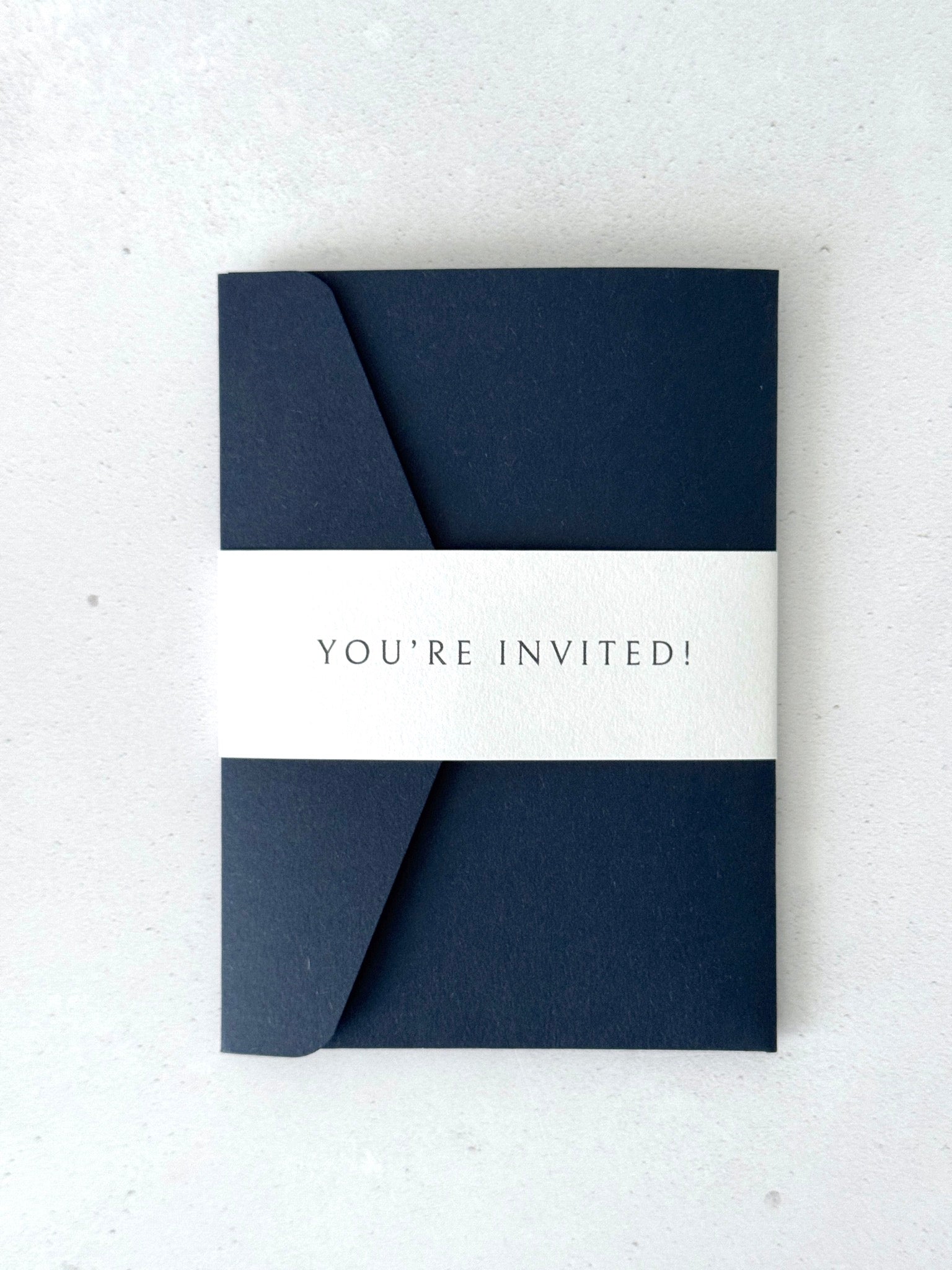 navy wedding invite with personalised printed bellyband.