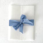 vellum wrap upgrade for wedding invites with tied ribbon
