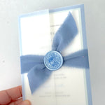 Jeni vellum jacket wrap wedding invite with cornflower blue tied silk ribbon handmade by zara