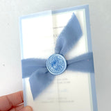 Jeni vellum jacket wrap wedding invite with cornflower blue tied silk ribbon handmade by zara