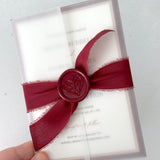 Jeni vellum sleeve wedding invite with burgundy tied silk ribbon and wax seal