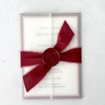 Burgundy wedding invite with transparent vellum paper wrap and ribbon bow