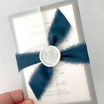 Jeni vellum jacket wrapped wedding invite with navy blue tied silk ribbon