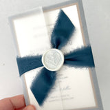 Jeni vellum jacket wrapped wedding invite with navy blue tied silk ribbon