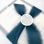 Navy blue tied silk ribbon and pearl wax seal wedding invite