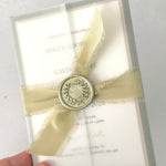 Vellum wrapped postcard wedding invite with sage green silk ribbon and wax seal