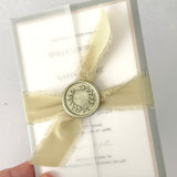 Vellum wrapped postcard wedding invite with sage green silk ribbon and wax seal