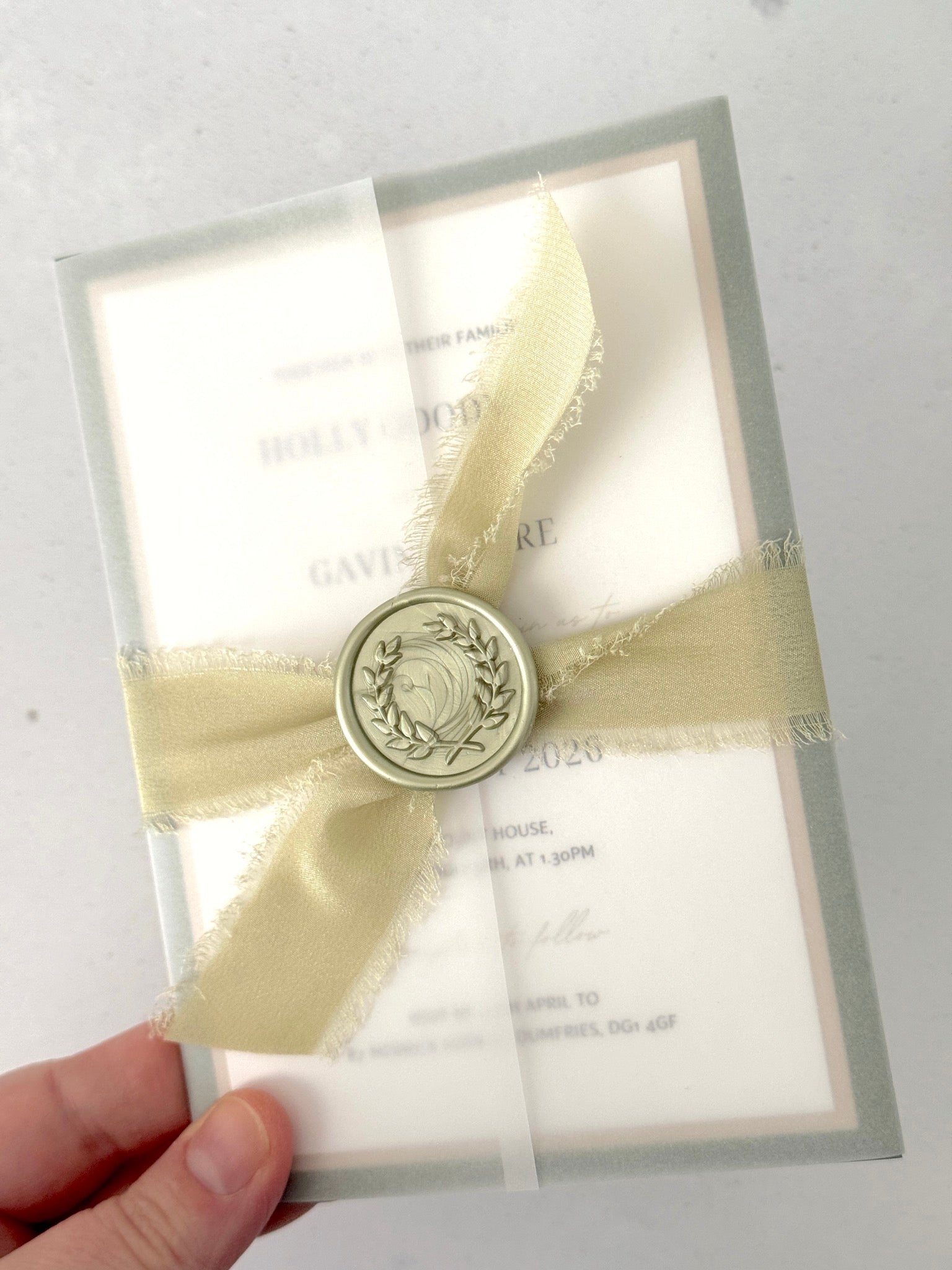 Vellum wrapped postcard wedding invite with sage green silk ribbon and wax seal