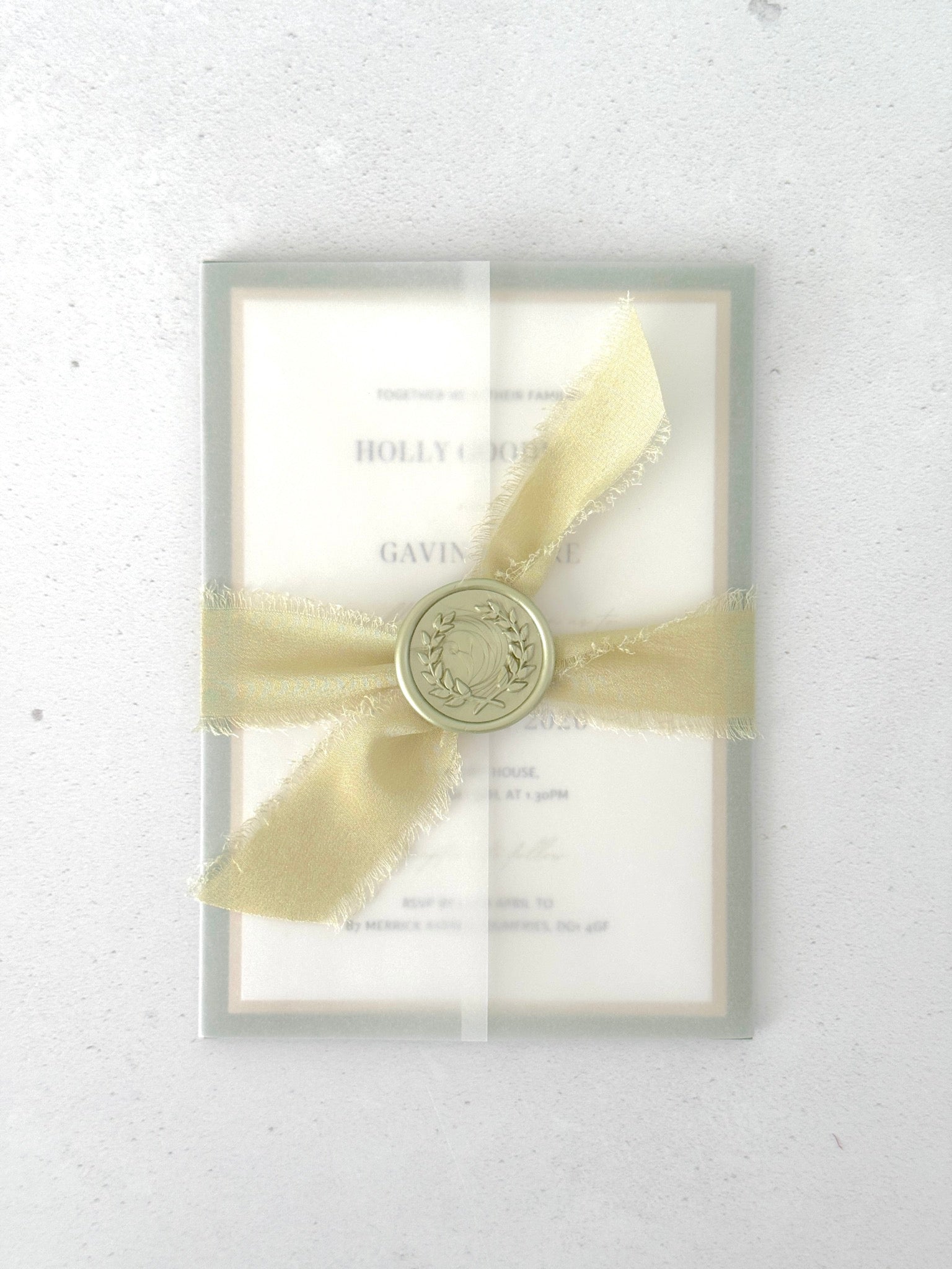 Handmade wedding invite with transparent vellum wrap, silk ribbon and wax seal closure