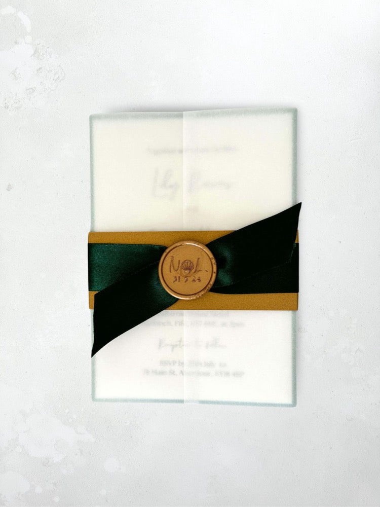 Vellum wrap invite with emerald green satin ribbon, belly band and custom gold wax seal