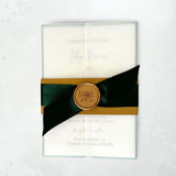 Vellum wrap invite with emerald green satin ribbon, belly band and custom gold wax seal