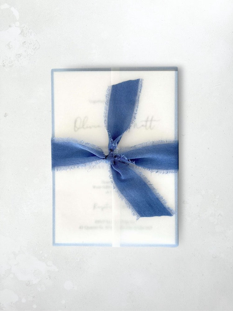 Jeni vellum jacket wrap wedding invite with cornflower blue tied silk ribbon handmade by zara