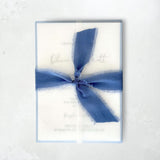 Jeni vellum jacket wrap wedding invite with cornflower blue tied silk ribbon handmade by zara