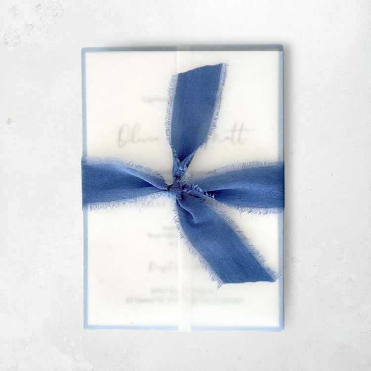 Jeni vellum jacket wrap wedding invite with cornflower blue tied silk ribbon handmade by zara