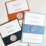 Group of lyn style belly band wedding invitations with handmade wax seals