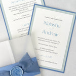 dusty blue postcard wedding invite and details card with vellum wrap, belly band, silk ribbon, and wax seal