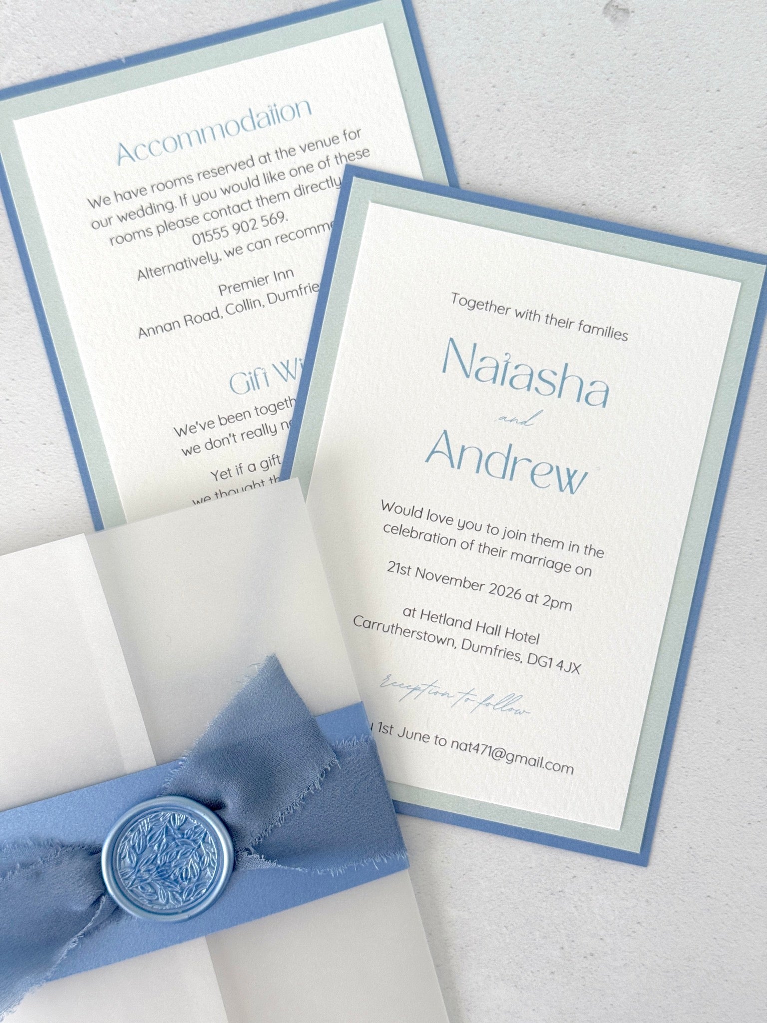 dusty blue postcard wedding invite and details card with vellum wrap, belly band, silk ribbon, and wax seal