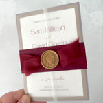 Lyn burgundy belly band and silk ribbon with gold wreath wax seal wedding invite in a vellum wrap