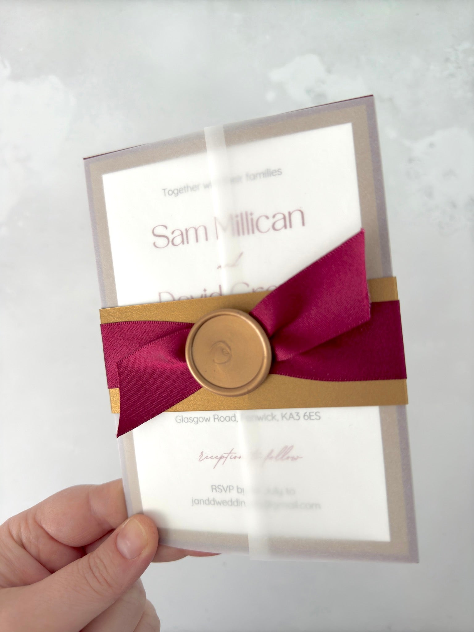 Lyn burgundy red and gold vellum wrapped wedding invite with belly band and wax seal