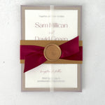 Gold and burgundy red belly band on see thru paper wrapped wedding invite